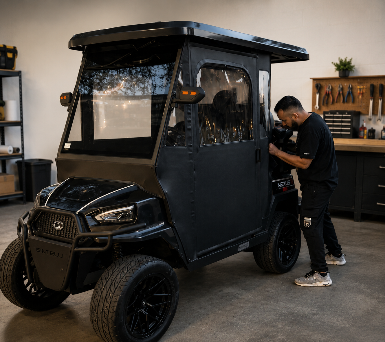 Technician fitting a custom enclosure on a black golf cart